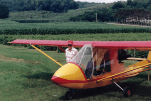 Bernard Kriesel's love for aviation is shown here as he poses next to an airplane he built and flew.